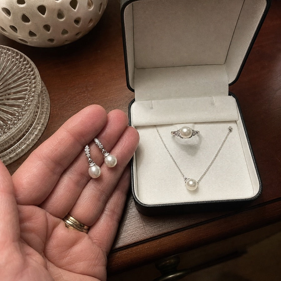 Barbara showing her pearl drop earrings